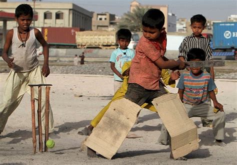 Poor kids playing on the streets of India. (x-post r/cricket) : pics