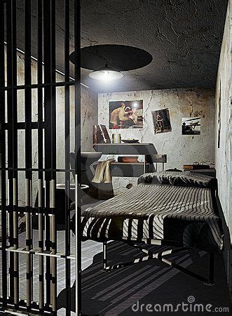 Interior of a prison cell. A mans cell with boxing images on the walls ...