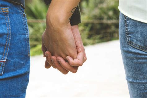 Man and woman holding hands stock photo