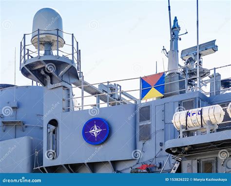 The Blue Nato Logo on a Side of a Large Gray Modern Warship with Radars ...