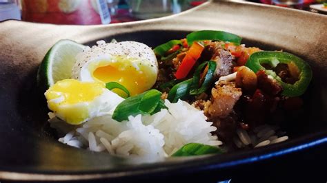 Sisig with peppers, poached egg and rice. Filipino Food.