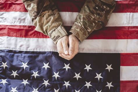 American Soldier Mourning and Praying with the American Flag in Front ...