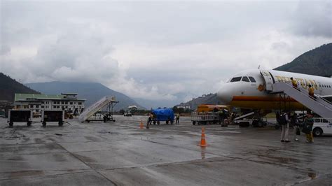 Airplane landing in Paro International Airport, Bhutan shot from tarmac ...