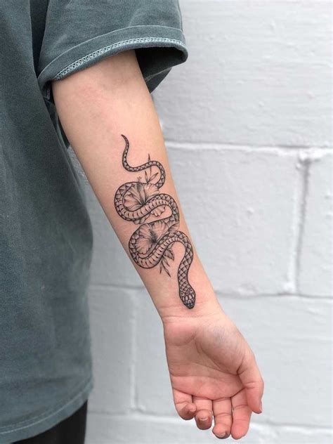 Snake Tattoo with Hibiscus | Snake tattoo design, Hand tattoos, Tattoos for women