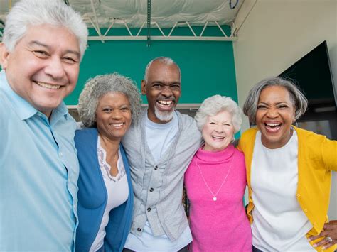 Diverse group of seniors smiling together with arms around each other | Deborah Foundation