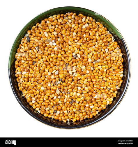 top view of unhulled proso millet grains in round bowl isolated on white background Stock Photo ...