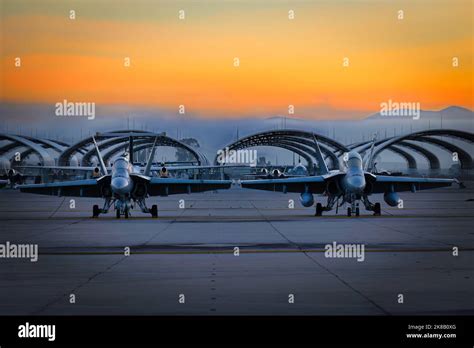 Two US Marine Corps FA-18 Hornets sit on the tarmac at sunrise for the 2022 Miramar Airshow in ...