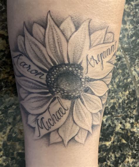 my personal tattoo. Sunflower with my kid's names on the petals. Aryanna , Aaron amd Michael ...