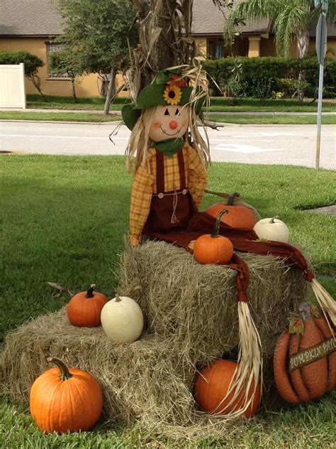 Scarecrow, pumpkin and hay bales. Cute fall display and photo op for the young kids. # ...