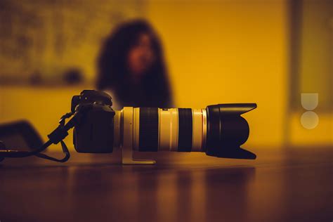 Black Sony Dslr Camera on Green Grass in Front of Brown and Green Mountain · Free Stock Photo