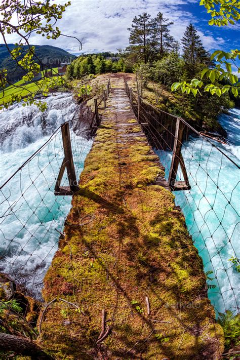 Suspension bridge over the mountain river, Norway. Stock Photo by cookelma