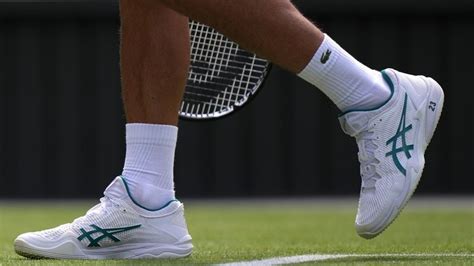 Novak Djokovic plays at Wimbledon with the number '23' printed on his ...