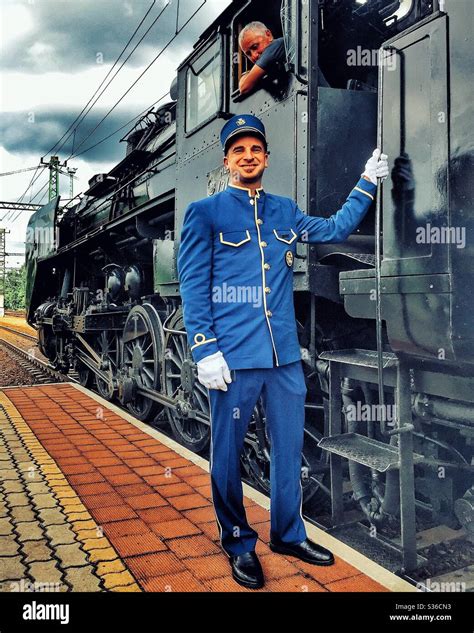 Uniformed Orient Express attendant with steam locomotive Stock Photo ...