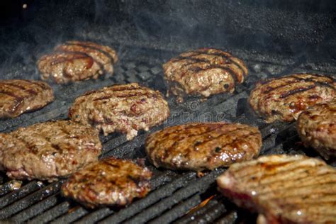 Hamburgers on a grill stock image. Image of grill, flame - 14552263