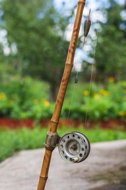 Premium Photo | Old fishing rod on nature background