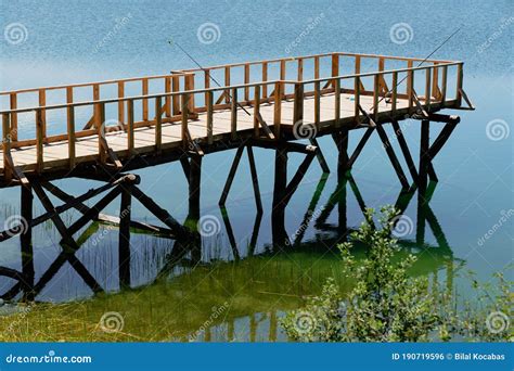 Catching Fish on Wooden Pier by the Lake Stock Photo - Image of lake, fisherman: 190719596