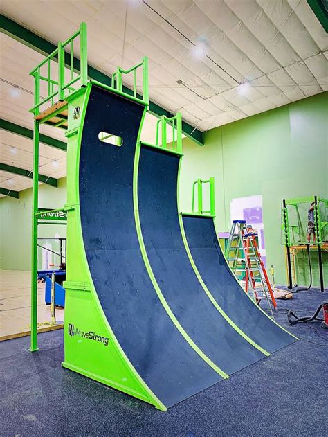 a skateboard ramp in the middle of an indoor area with ladders and ...