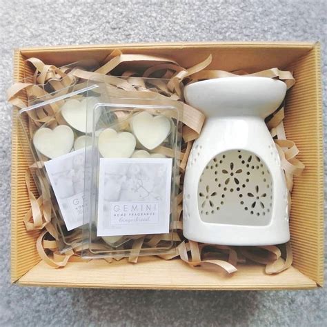 an open box containing candles and soaps