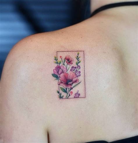 Flower wreath tattoo on the left shoulder blade.