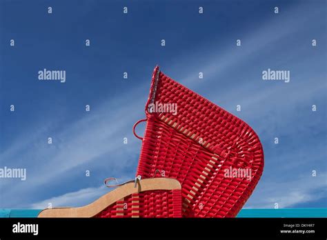 Red beach chair in front of blue sky, beach club, Hamburg Germany Stock Photo - Alamy