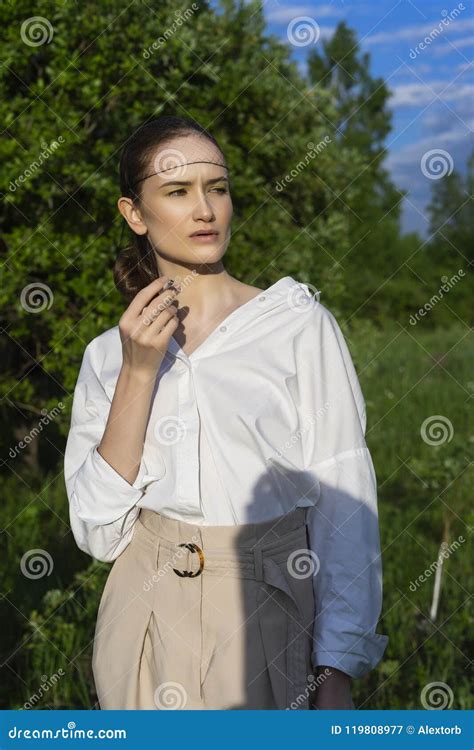 Beautiful Stylish Smoking Girl Wearing a Trendy White Shirt, Beige Trousers and Mesh Under the ...