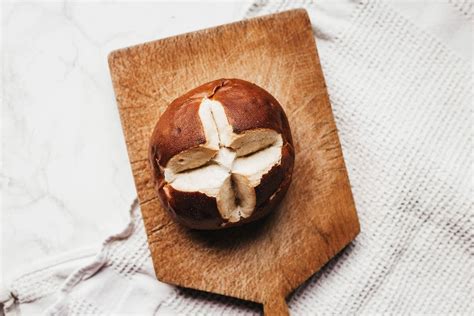 Smoked chicken breast on a round wooden kitchen Board with dill and cherry tomatoes - Creative ...