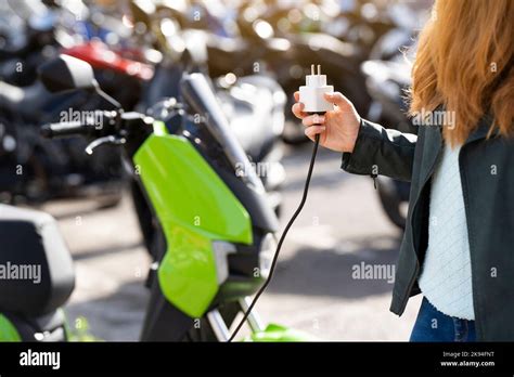 Charging an electric motorcycle in a city parking lot Stock Photo - Alamy