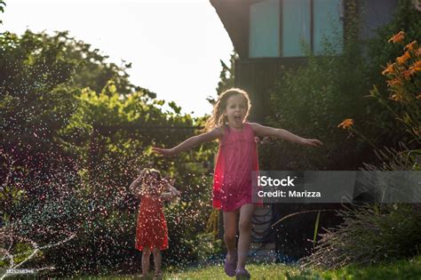 Kids Playing With Garden Sprinkler Stock Photo - Download Image Now - 2 ...