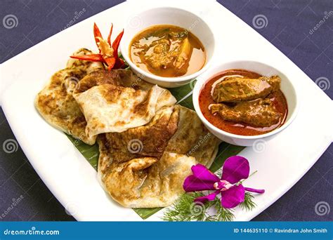 ROTI CANAI with CHICKEN CURRY Stock Photo - Image of indianinfluenced, flatbread: 144635110