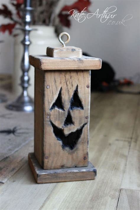 a wooden box with a carved pumpkin face on it