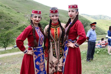 three women dressed in costume standing next to each other on a hill ...