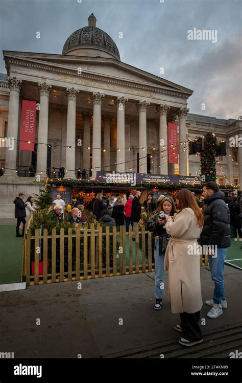 London, UK - Nov 20 2023: Trafalgar Square Christmas Market, London with people at an outdoor ...