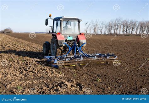 Tractor Harrowing Soil Stock Photography | CartoonDealer.com #165560984