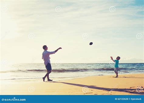 Father and Son Playing Catch Throwing Football Stock Photo - Image of fatherhood, people: 62122620