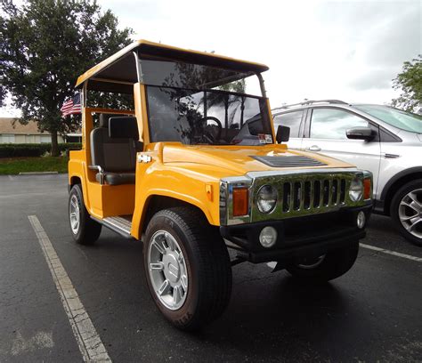 Yellow H3 Hummer Golf Cart says 'Bee Happy' in Sun City Center, Florida