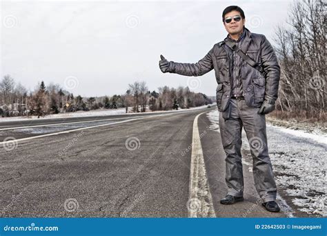 Hispanic Man Hitchhiking In Canada Stock Photos - Image: 22642503