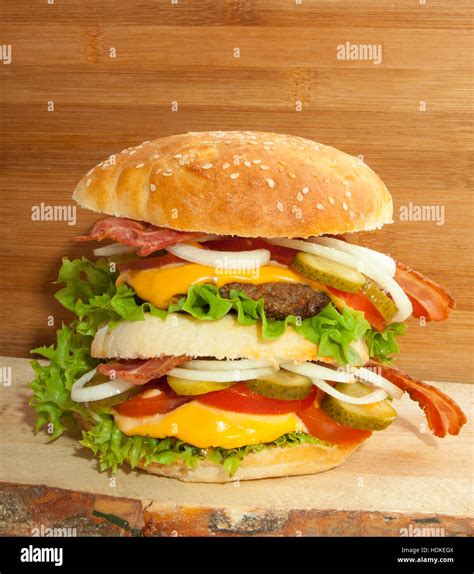 Tasty double homemade hamburger on natural wood Stock Photo - Alamy