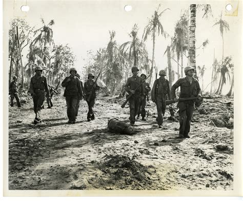 7th Infantry Division soldiers walk past the dead body of fellow ...