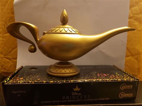 a golden teapot sitting on top of a black box