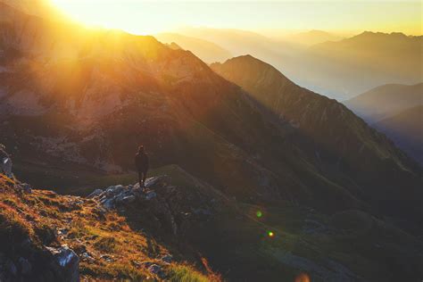 Person Standing on Rock Cliff during Golden Hour · Free Stock Photo