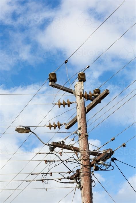 Image of Wooden electricity pole with wires and insulators - Austockphoto