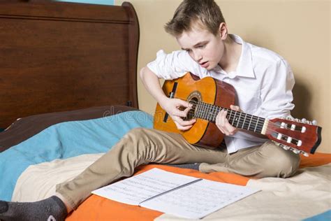 Teenage Boy Playing Guitar in Her Bedroom Stock Image - Image of happy ...