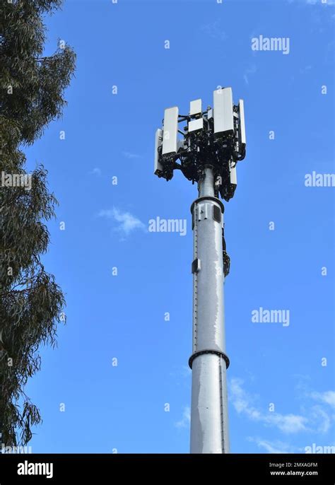 5G mobile cell phone tower against a blue sky Stock Photo - Alamy