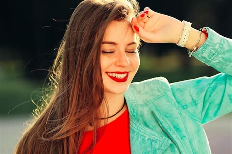 Premium Photo | Smiling young woman with red lips feeling happy in soft ...