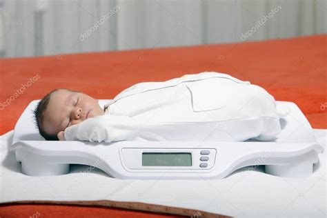 Baby on weight scale — Stock Photo © benedamiroslav #20564959