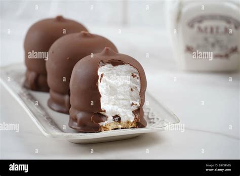 Chocolate-coated marshmallow. Krembo on the table with a cookies. Classic Israeli childhood ...