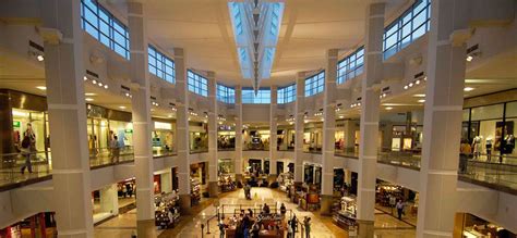 the inside of a mall filled with lots of people