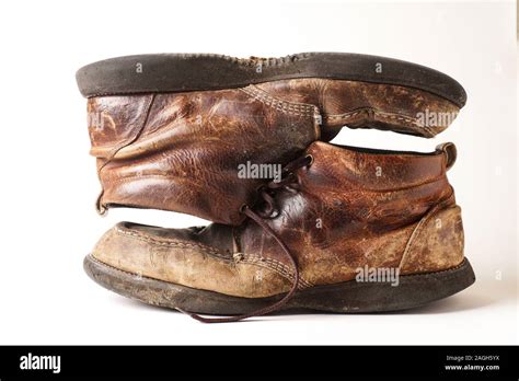 Dirty pair of man's old leather boots on white background Stock Photo ...