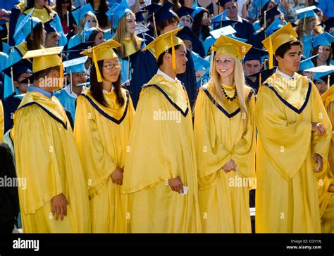 Wearing caps and gowns, high school seniors participate in graduation Stock Photo, Royalty Free ...