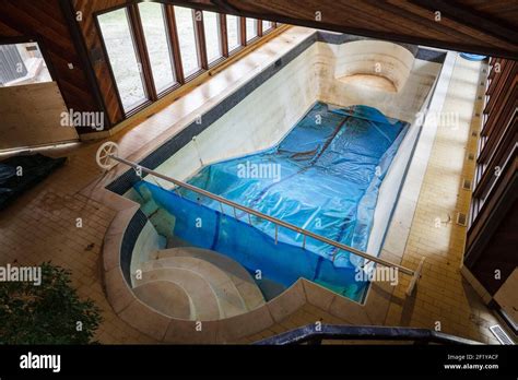 An indoor swimming pool inside of an abandoned mansion Stock Photo - Alamy